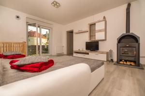 a bedroom with a large bed with a fireplace at LTE Apartments in Maribor