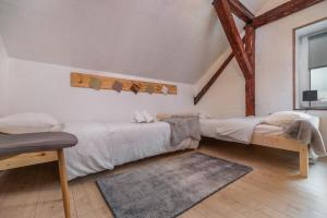 a bedroom with two beds and a rug at LTE Apartments in Maribor