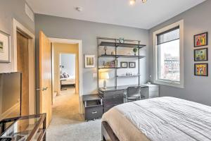 a bedroom with a bed and a desk and a window at Downtown Condo with Rooftop Patio and City Views! in Omaha