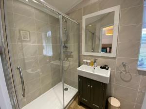 a bathroom with a shower and a sink at Holicarrs - Gingerlily in Riccall