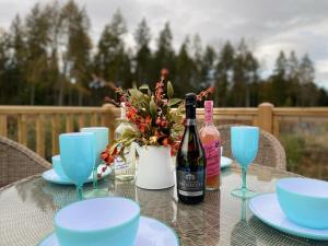 a table with a bottle of wine and glasses at Holicarrs - Gingerlily in Riccall