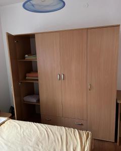 1 dormitorio con armarios de madera y 1 cama en Apartments D&D, en Požarevac