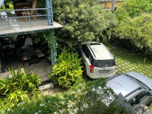 a car parked in the yard of a house at Rain Homestay in Alleppey
