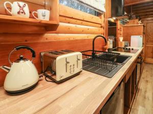 a kitchen with a toaster and a tea kettle on a counter at Whitemoor Lodge in Barnoldswick