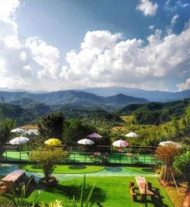 a resort with a view of the mountains at Flower hill 180 in Chiang Rai