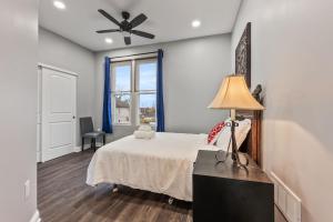 a bedroom with a bed and a ceiling fan at The Gathering House for Family and Friends in Columbus