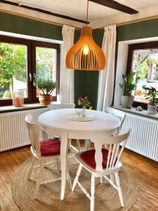 una sala da pranzo con tavolo e sedie bianchi di Gemütliches Studio-Apartment in Ostseenähe - Cosy Wulfi a Probsteierhagen