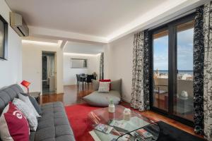 a living room with a couch and a glass table at Casa Sta Clara by An Island Apart in Funchal