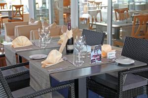 ein Tisch mit Gläsern und eine Flasche Wein darauf in der Unterkunft City Hotel Frankfurt Bad Vilbel in Bad Vilbel
