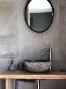 a bathroom with a stone sink and a mirror at Nanie - Villa centre-ville, piscine, wifi - La Teste de Buch in La Teste-de-Buch +28 photos