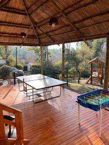 un patio con 2 mesas de ping pong y un cenador en Las Princesas Cabañas en Los Reartes