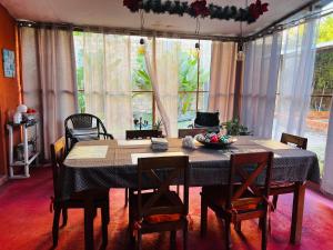 a dining room with a table and chairs and a table and chairsktop at Otorongo Guesthouse in Iquitos