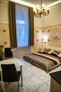 1 dormitorio con 1 cama grande y 1 mesa en Exclusive Apartmanok Szeged, en Szeged
