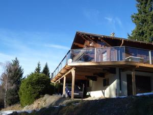 a house on a hill with a glass roof at Chalet traditionnel avec jacuzzi extérieur in Bex