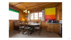 a kitchen with a table and chairs in a room at Chalet traditionnel avec jacuzzi extérieur in Bex