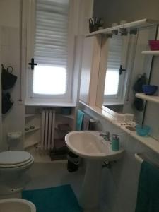 a bathroom with a sink and a toilet and a window at Mascagni Rooms in Florence