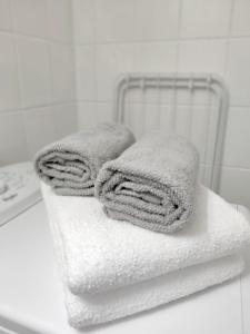 a pile of towels sitting on top of a towel rack at Beautiful studio in the heart of Lahti in Lahti