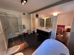 a bathroom with a tub and two sinks and a shower at Large villa for 20 guests on large estate with private pool and tennis court Big conference room with facilities VILLAITALY EU in Cairo Montenotte