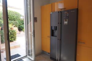 a refrigerator in a room next to a sliding glass door at Villa la Felicite in Saint-Jean-Cap-Ferrat