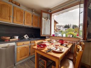 a kitchen with a wooden table and a window at Chalet familial à St Marcel avec terrasse, 6 pers, 3 chambres - FR-1-344-1051 in Saint-Marcel