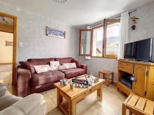 a living room with a couch and a coffee table at Chalet Saint-Martin-de-Belleville, 5 pièces, 6 personnes - FR-1-344-1051 in Saint-Marcel