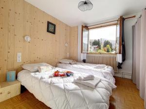 two twin beds in a room with wooden walls at Chalet familial à St Marcel avec terrasse, 6 pers, 3 chambres - FR-1-344-1051 in Saint-Marcel