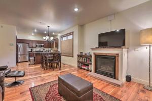 a living room with a fireplace and a tv at Cozy Central Glenwood Springs Condo with 2 Decks! in Glenwood Springs