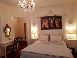 a bedroom with a bed and a chandelier at Luxury House B&B in Bassano del Grappa