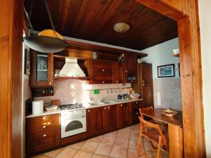 a kitchen with a stove and a sink and a table at Sole Luna Mare in Pozzuoli