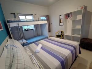 a bedroom with a bed and a bunk room with a ladder at Residencial Sol Nascente in Aracaju