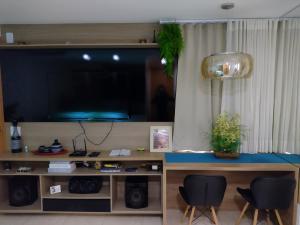 a living room with a large flat screen tv at Apartamento mobiliado e aconchegante in Rio de Janeiro