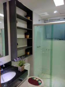 a bathroom with a glass shower and a sink at Apartamento mobiliado e aconchegante in Rio de Janeiro