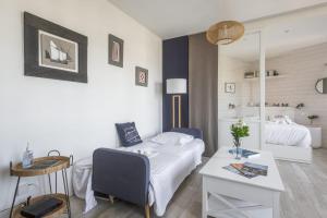 a bedroom with a bed and a desk and a bed and a table at Studio Limpo - Welkeys in Hendaye
