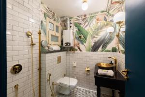 a bathroom with a toilet and a sink in it at The Neat Nostalgic 1BDR Studio Cairo's Downtown 20B in Cairo
