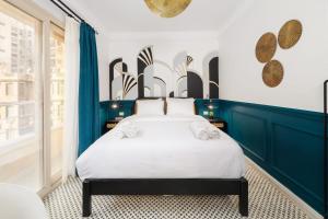 a bedroom with a white bed with blue walls at The Neat Nostalgic 1BDR Studio Cairo's Downtown 20B in Cairo