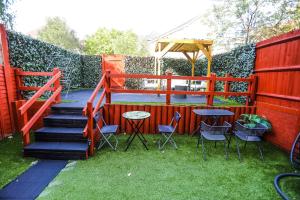 a garden with a staircase and chairs and a table at SureBillionaire Homes in Thamesmead