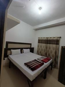 a bedroom with a bed in a room at M Cube Service Apartments in Sakleshpur