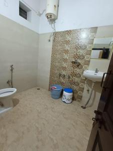 a bathroom with a sink and a toilet at M Cube Service Apartments in Sakleshpur