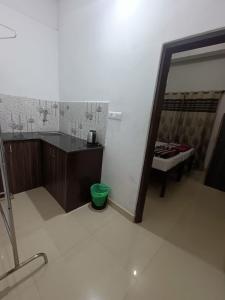 a bathroom with a sink and a mirror at M Cube Service Apartments in Sakleshpur