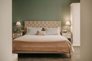 a bedroom with a large bed with two night stands at Palazzo Natoli Boutique Hotel in Palermo