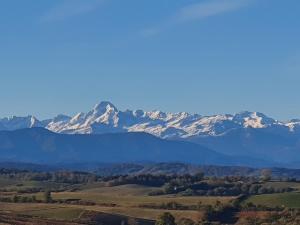 a mountain range with snow capped mountains in the distance at Villa le Moulin in Unzent