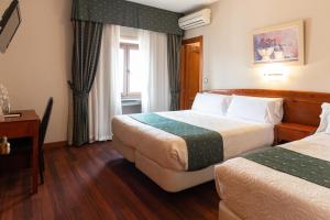 Posteľ alebo postele v izbe v ubytovaní Hotel Alameda Málaga