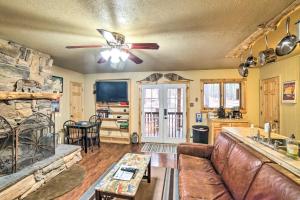 a living room with a couch and a fireplace at Rustic Condo with Patio Walk to Angel Fire Resort! in Angel Fire
