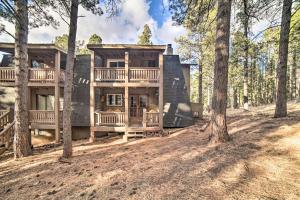 a large house in the woods with trees at Rustic Condo with Patio Walk to Angel Fire Resort! in Angel Fire