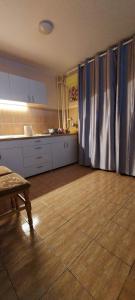 a kitchen with a wooden floor and curtains in a room at Apartament in Iaşi +15 photos