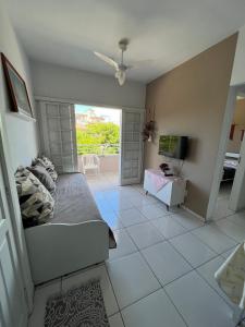 a living room with a bed and a television at Los Hermanos Residencial in Florianópolis