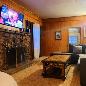 a living room with a couch and a flat screen tv at Green Cabin in Big Bear Lake 3 bdr Pets Friendly in Big Bear City