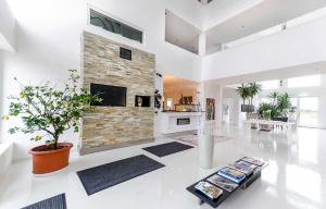 a living room with a fireplace and a tv at Designhotel Youngstar in Mannheim +12 photos