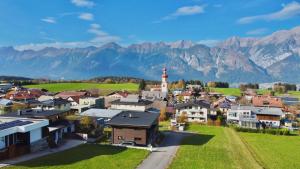 an aerial view of a small town with mountains in the background at Black Forest Lodges - gehobene Ferienwohnungen mit Privatsaunas in Tulfes