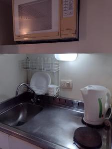 encimera de cocina con fregadero y microondas en Departamento Corrientes Av. en Buenos Aires